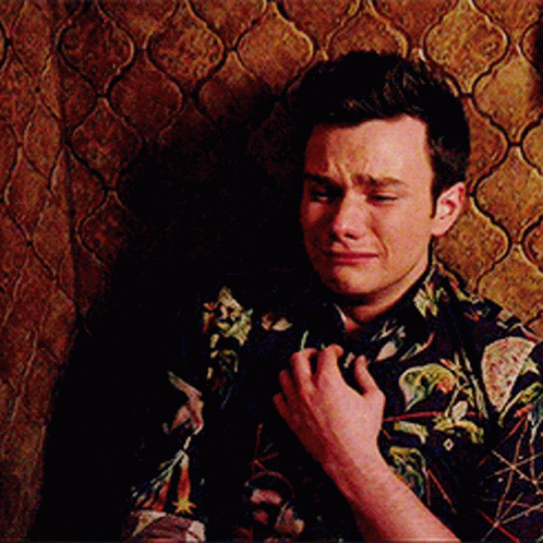 A Man Wearing A Floral Shirt Is Crying GIF