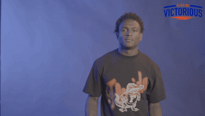 A Man Wearing A Florida Victorious Shirt Is Dancing GIF