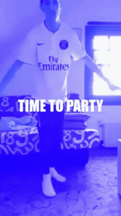 A Man Wearing A Fly Emirates Shirt Is Dancing In A Room GIF