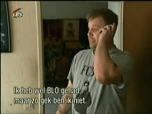 A Man Wearing A Fox Shirt Is Talking On The Phone GIF