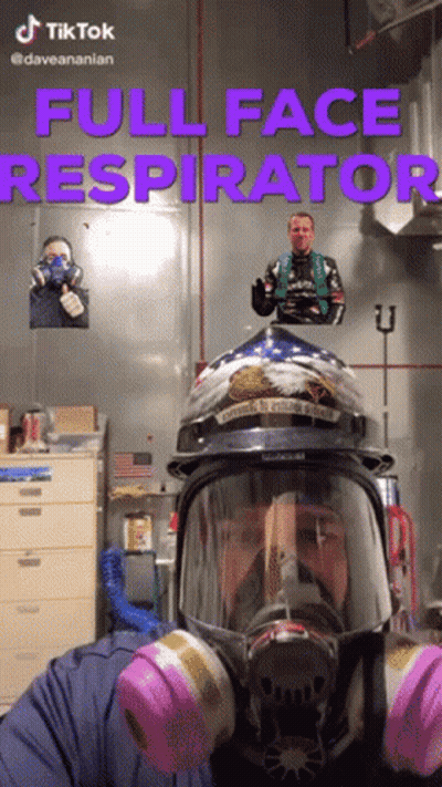 A Man Wearing A Full Face Respirator With A Helmet On GIF