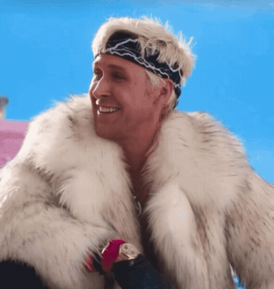A Man Wearing A Fur Coat And A Headband Smiles GIF