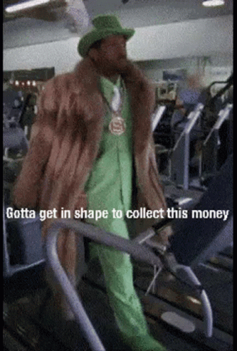 A Man Wearing A Fur Coat And Green Suit Is Walking On A Treadmill With The Caption Gotta Get In Shape To Collect This Mo GIF