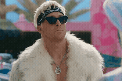 A Man Wearing A Fur Coat And Sunglasses Has A Horseshoe Necklace GIF