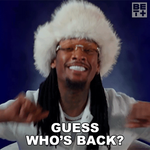 A Man Wearing A Fur Hat Is Smiling And Says Guess Who 'S Back GIF