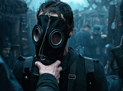A Man Wearing A Gas Mask Is Being Touched By Another Man GIF