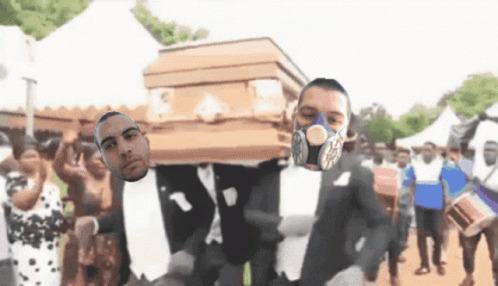 A Man Wearing A Gas Mask Is Carrying Another Man On A Coffin GIF