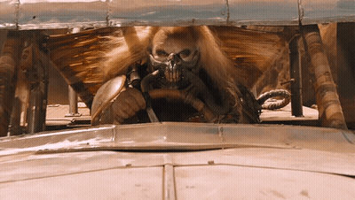 A Man Wearing A Gas Mask Is Driving A Vehicle GIF