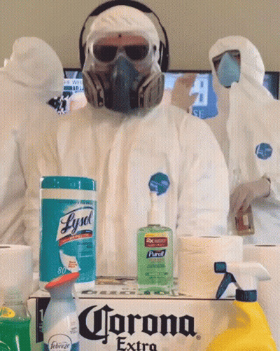 A Man Wearing A Gas Mask Is Standing Next To A Box Of Corona Extra GIF