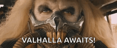 A Man Wearing A Gas Mask With The Words Valhalla Awaits On The Bottom GIF