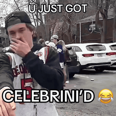 a man wearing a georgia jersey is covering his mouth with his hand