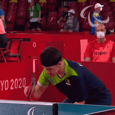 A Man Wearing A Germany Shirt Is Playing Table Tennis GIF