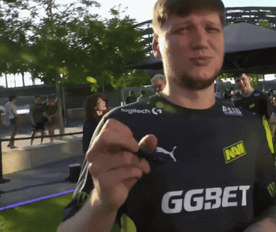 A Man Wearing A Ggbet Shirt Holds A Pen GIF