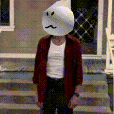 A Man Wearing A Ghost Mask Is Standing On A Set Of Steps GIF