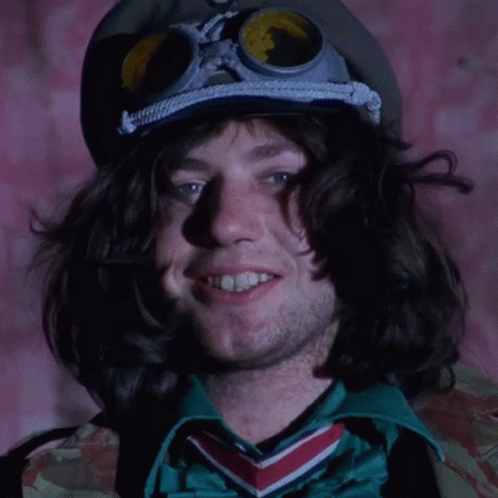 A Man Wearing A Goggles And A Hat With The Letter K On It GIF