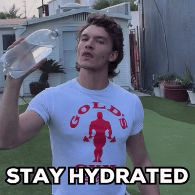 A Man Wearing A Gold 'S Gym T-Shirt Is Holding A Bottle Of Water GIF