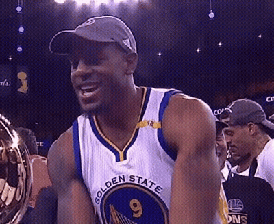 A Man Wearing A Golden State Warriors Jersey Is Holding A Trophy . GIF