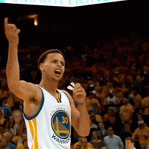 A Man Wearing A Golden State Warriors Jersey Stands On A Basketball Court GIF