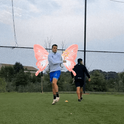 A Man Wearing A Gray Jacket And Blue Shorts Has Pink Wings On His Arms GIF