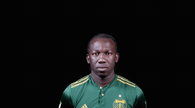 A Man Wearing A Green Adidas Shirt With A Star On It GIF