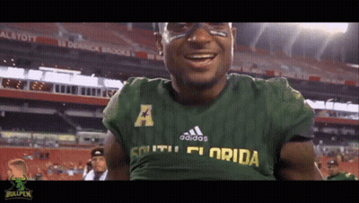 A Man Wearing A Green Adidas South Florida Shirt GIF