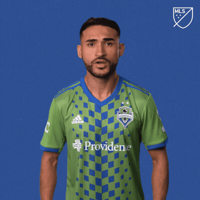 A Man Wearing A Green And Blue Shirt With The Word Vamos On It GIF