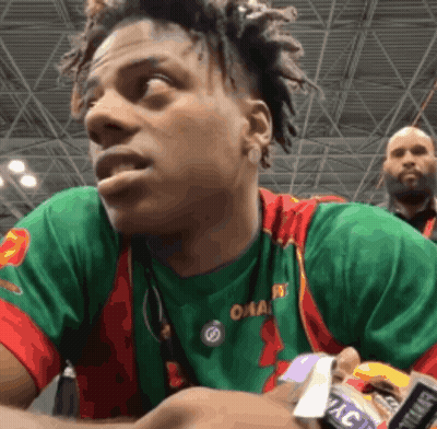 A Man Wearing A Green And Red Shirt That Says Omaha On It GIF