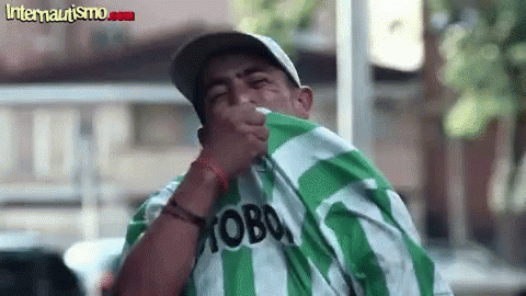 A Man Wearing A Green And White Striped Shirt With The Word Moba On It . GIF