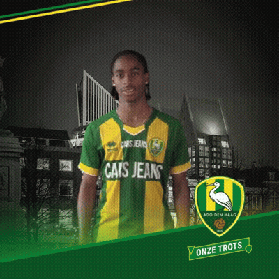 A Man Wearing A Green And Yellow Cats Jeans Shirt GIF