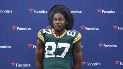 A Man Wearing A Green And Yellow Jersey With The Number 27 On It GIF