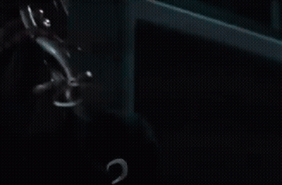 A Man Wearing A Green Bandana And A Watch Is Looking Up At The Sky . GIF