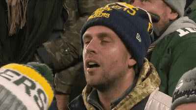 A Man Wearing A Green Bay Packers Hat Looks Tired GIF