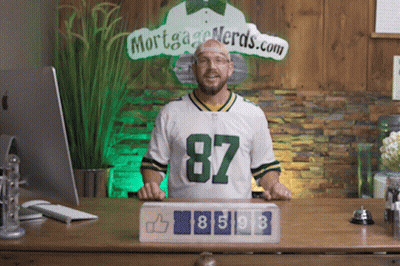 A Man Wearing A Green Bay Packers Jersey Stands In Front Of A Sign That Says Mortgage Nerds.com GIF