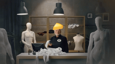 A Man Wearing A Green Bay Packers Shirt Holds A Receipt And A Piece Of Cheese On His Head GIF