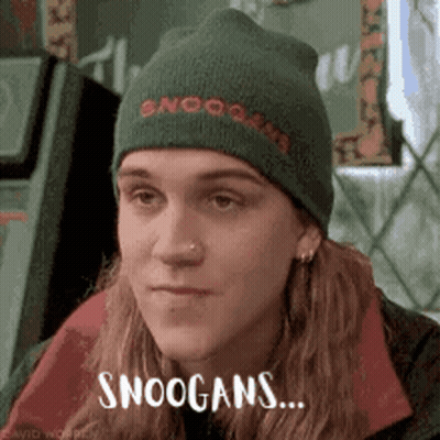 A Man Wearing A Green Beanie With The Words Snoogans On It GIF