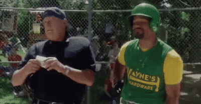 A Man Wearing A Green Helmet And A Yellow Shirt That Says Wayne 'S Hardware Is Talking To A Police Officer GIF