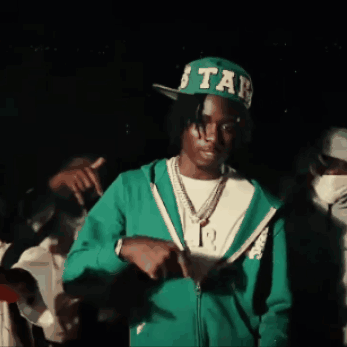 A Man Wearing A Green Jacket And A Green Hat With The Word Star On It GIF