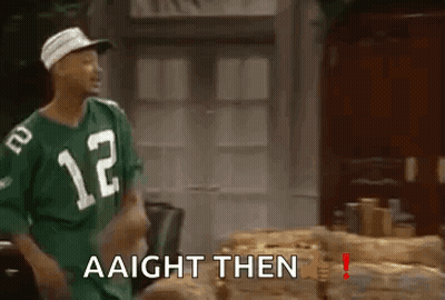 A Man Wearing A Green Jersey With The Number 12 On It Is Standing In Front Of A Table . GIF