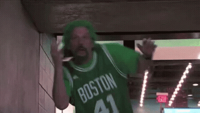 A Man Wearing A Green Jersey With The Number 41 On It Is Walking Through A Tunnel . GIF