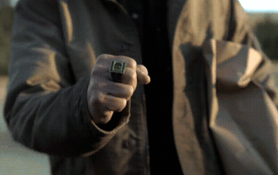 A Man Wearing A Green Lantern Ring Is Pointing At Something GIF