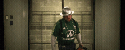 A Man Wearing A Green Leatherman Shirt And A Hard Hat GIF
