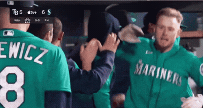 A Man Wearing A Green Mariners Jersey With The Number 8 On It GIF
