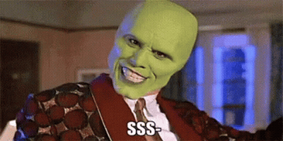 A Man Wearing A Green Mask And A Red Jacket Is Smiling And Saying Sss . GIF