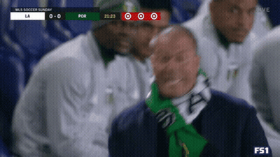 A Man Wearing A Green Scarf Is Watching A Soccer Game On Tv GIF