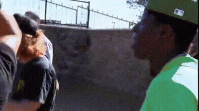 A Man Wearing A Green Shirt And A Hat With The Letter N On It GIF