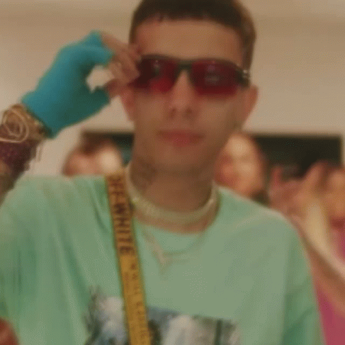 A Man Wearing A Green Shirt And A Yellow Belt With The Word Off White On It GIF