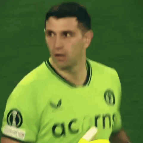 A Man Wearing A Green Shirt That Says Acorns On The Front GIF