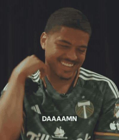 A Man Wearing A Green Shirt That Says Daaaamn On It GIF