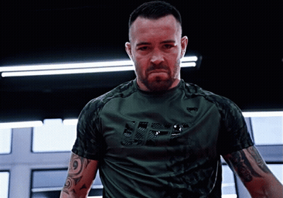 A Man Wearing A Green Shirt With The Word Ufc On It GIF