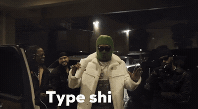 A Man Wearing A Green Ski Mask Is Holding A Cup Of Coffee And Says Type Shi GIF